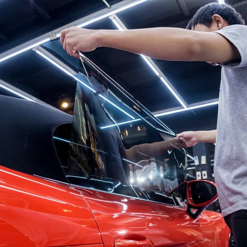 applying-tinting-foil-car-window-auto-service 1